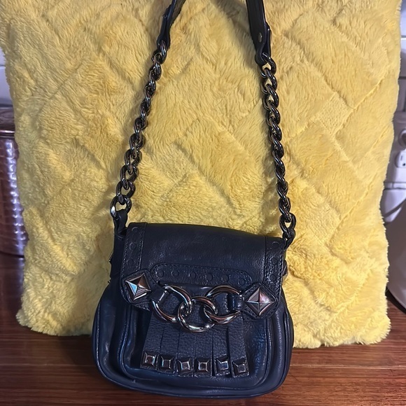As seen in Vogue. Michael kors 2006 collection. Black studded leather.